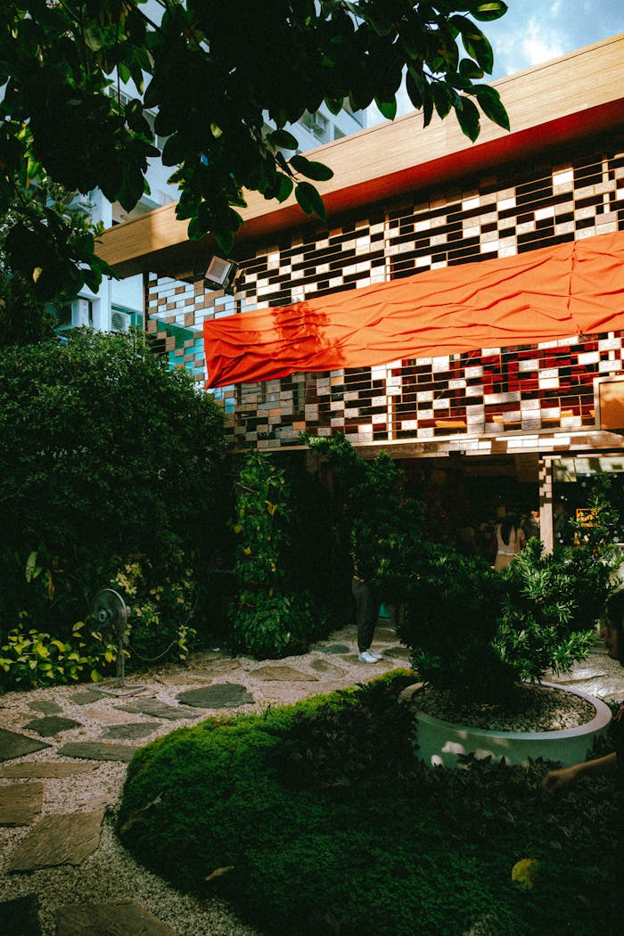 Explore a stylish outdoor cafe in Bangkok with unique architecture and lush greenery.